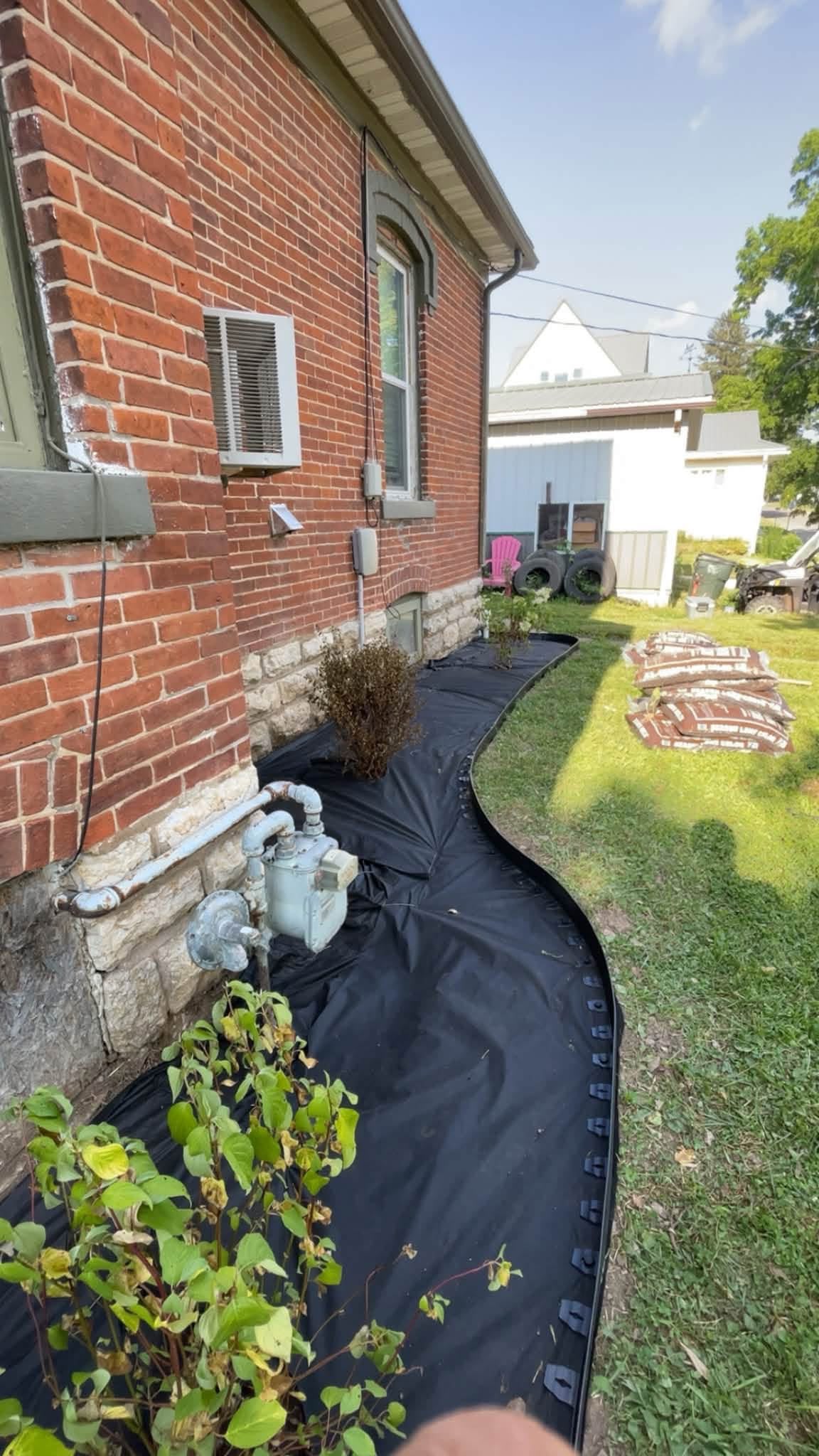 Careful preparation of a curved landscape bed beside a home